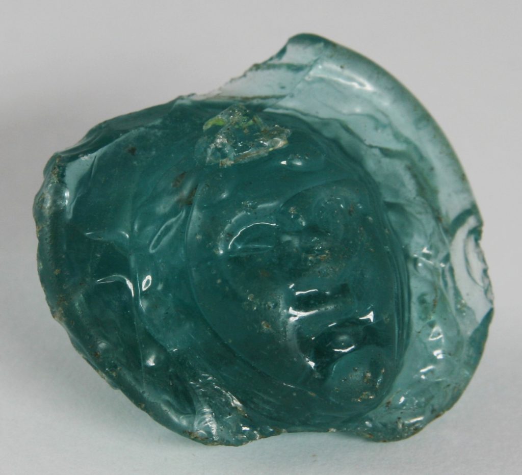 Close up of the Roman glass head from Poole museum.
