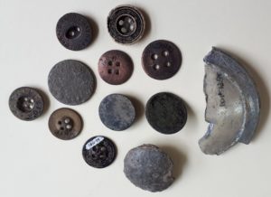 Collection of old buttons and a glass sherd
