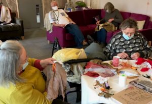 Group of people sewing in care home