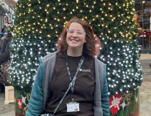 Katie Nichols standing by Christmas tree