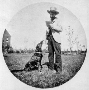 Hardy standing with a dog outside