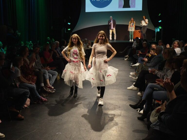 Two young people taking part in the sustainable fashion show