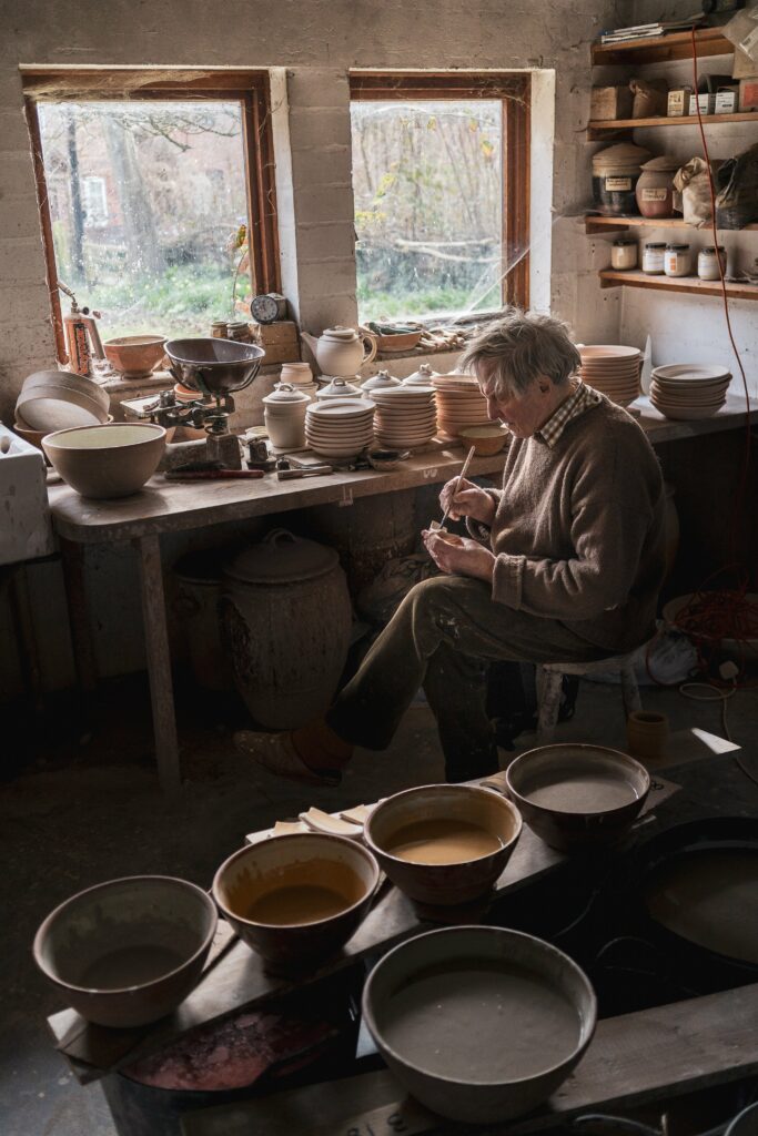 Richard Batterham glazing pots, 2019. © Stefan Morris/Courtesy of Richard Batterham Estate