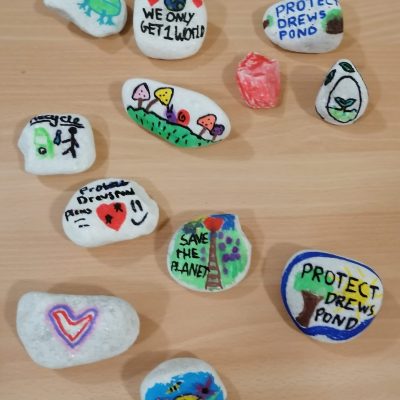 Small pebbles decorated with children's slogans.