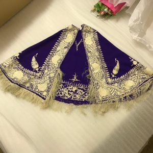 Intricately decorated blue velvet cape with gold fringing